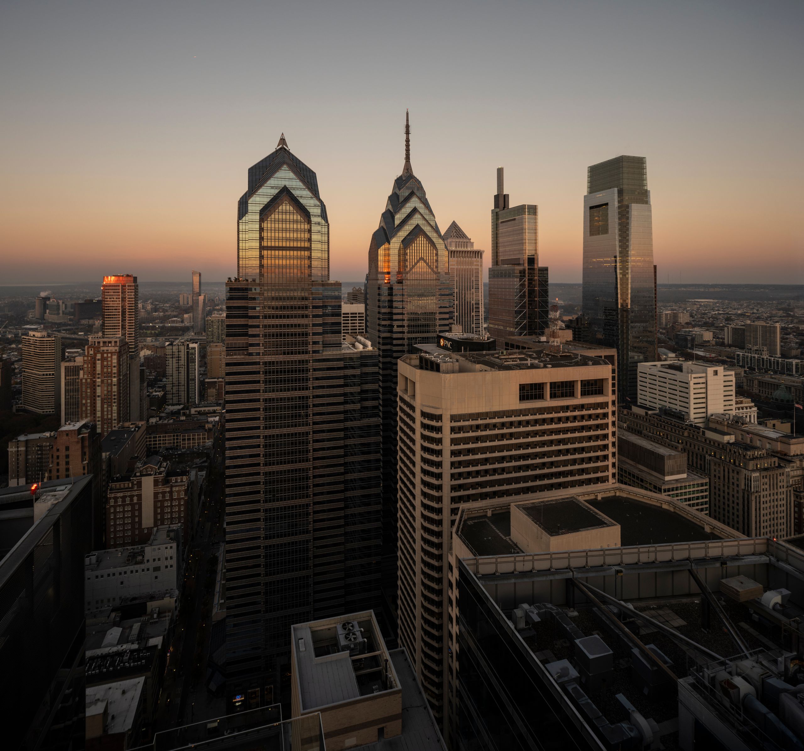 Breathtaking view of Philadelphia's modern skyline at sunset featuring iconic skyscrapers.
